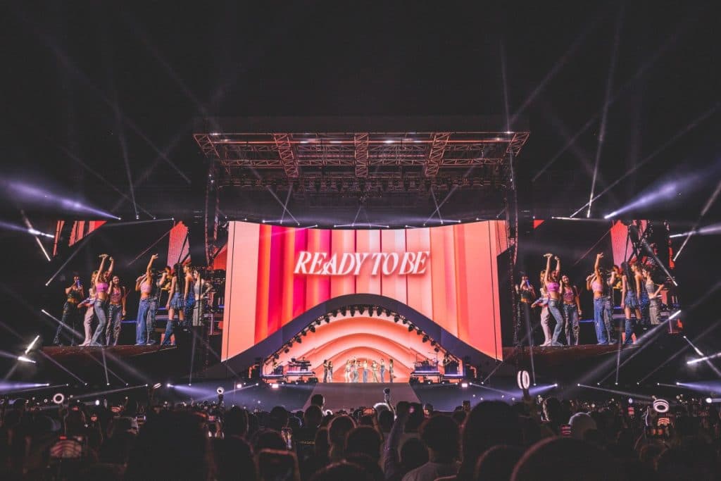 K-pop group Twice performing in front of a stadium crowd