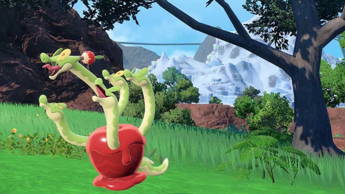 The Pokemon hydrapple pokes several heads out of a large apple