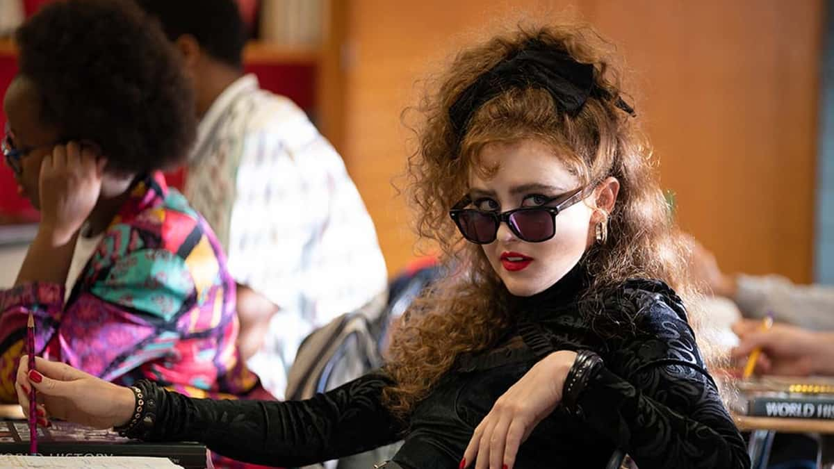 Kathryn Newton sitting at a school desk in Lisa Frankenstein.