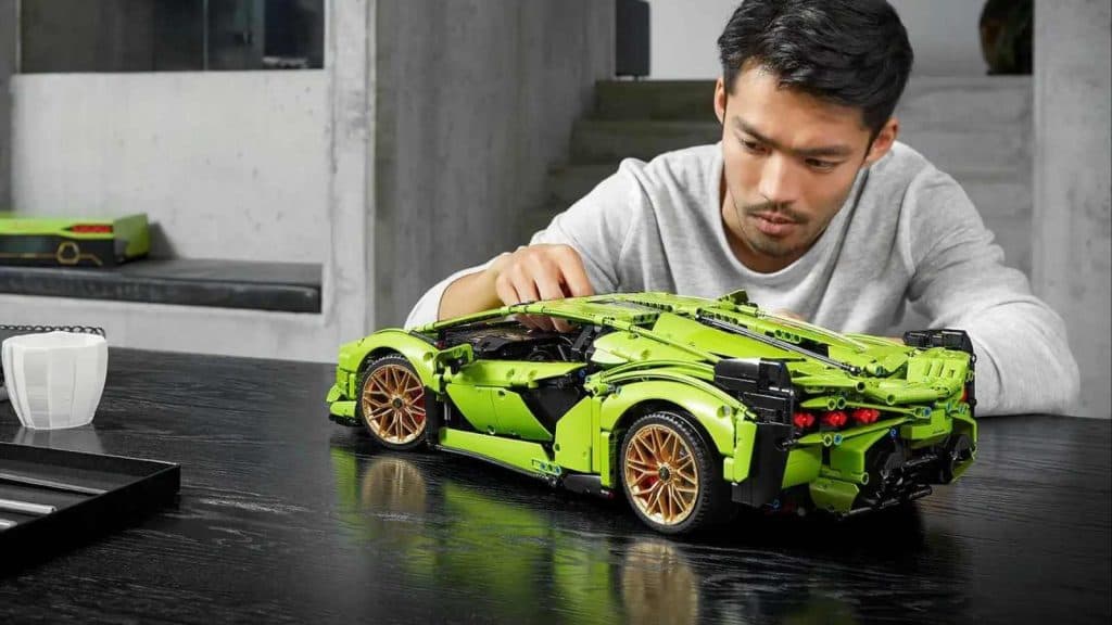 An adult admiring their LEGO Technic Lamborghini Sián FKP 37 set