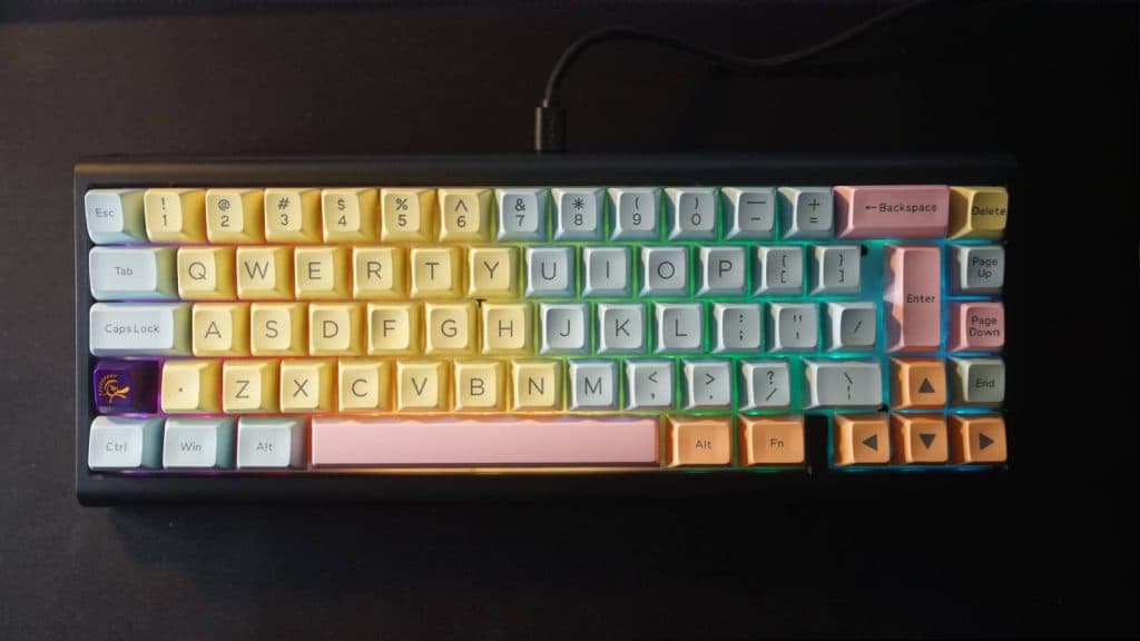 A top down view shows a mechanical keyboard on a black desk mat