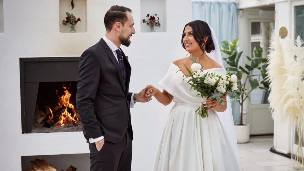 Meria and Oskar from Love is Blind at their wedding holding hands