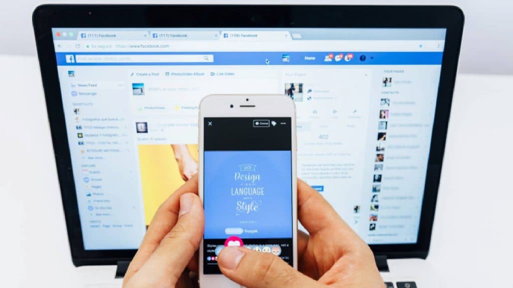 Facebook open on a phone and a computer