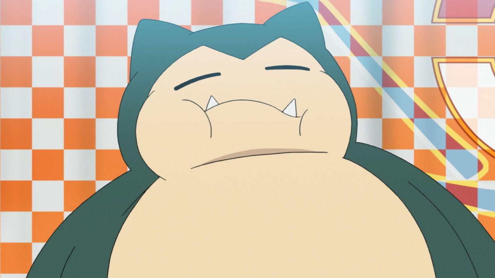 Snorlax asleep on checkered blanket from Pokemon anime.