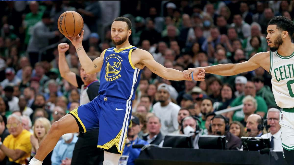 Jayso Tatum commits a take foul on Stephen Curry.