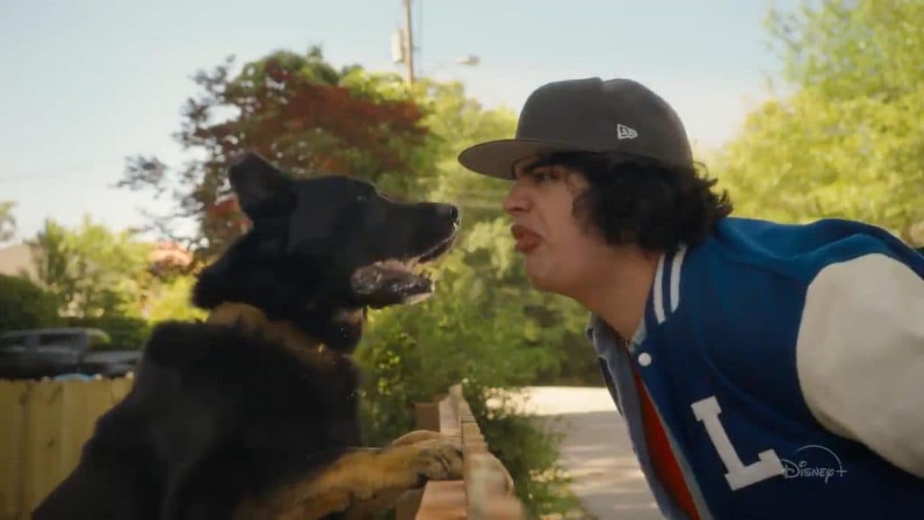 Just Beyond: Trevor Larkin stands in front of a dog and sticks his tongue out