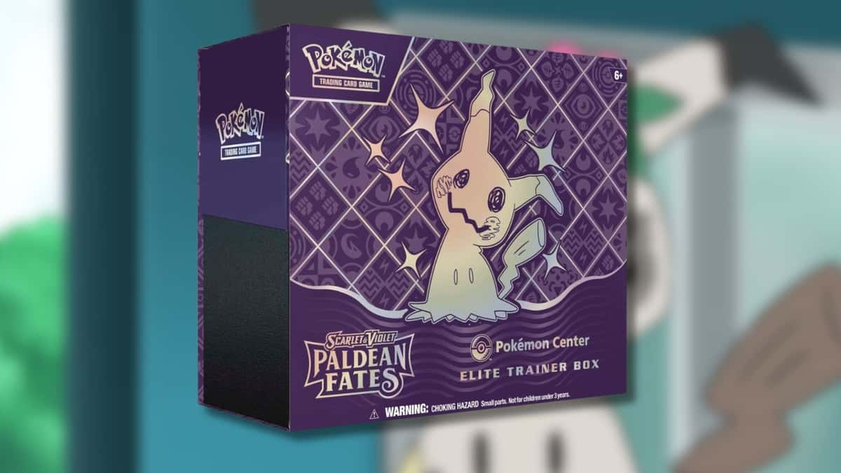 Paldean Fates ETB with Mimikyu background.