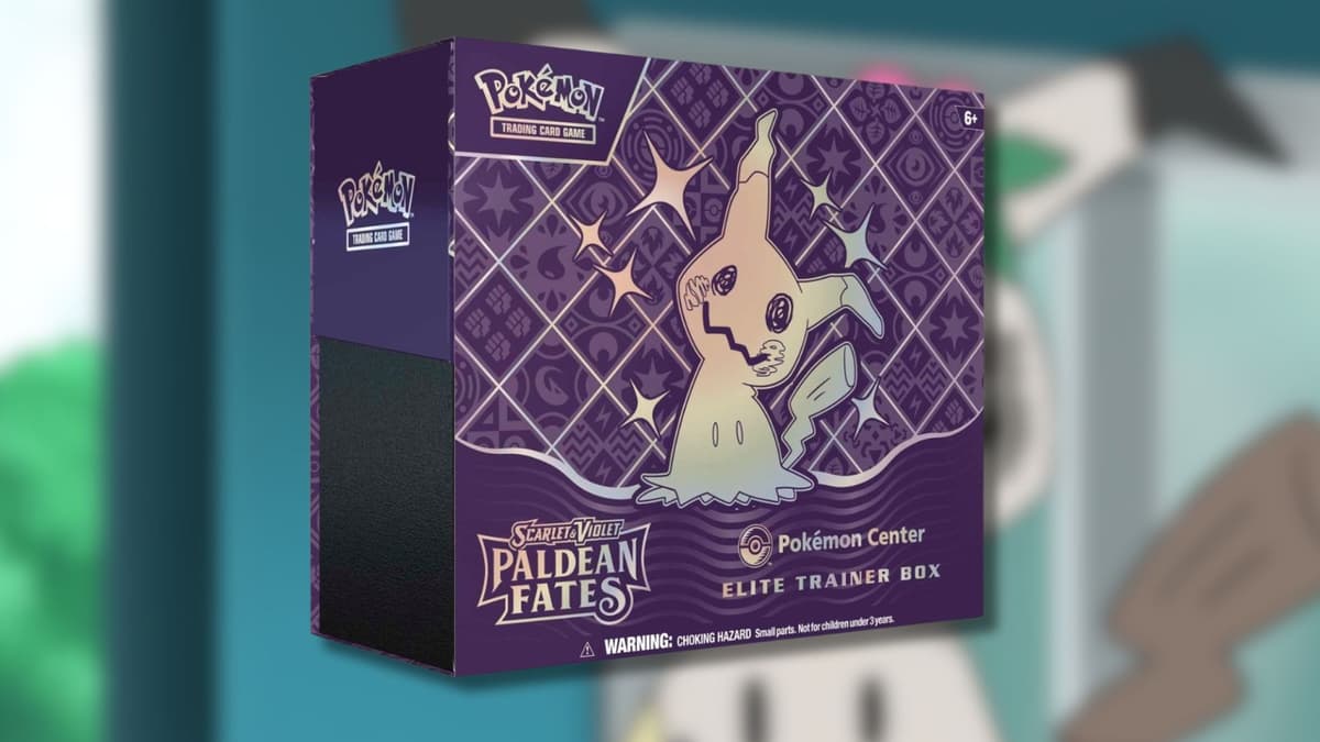 Paldean Fates ETB with Mimikyu background.