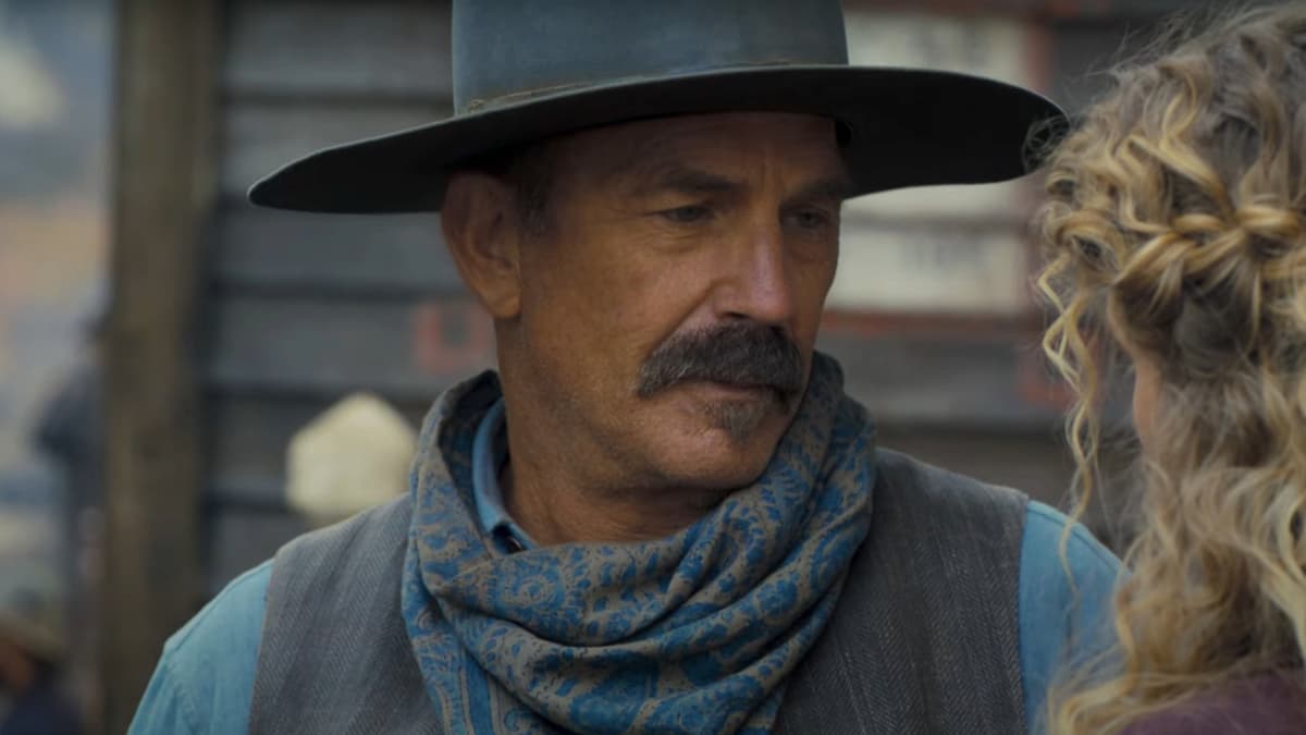 Kevin Costner in Horizon, wearing a cowboy hat and looking at a woman