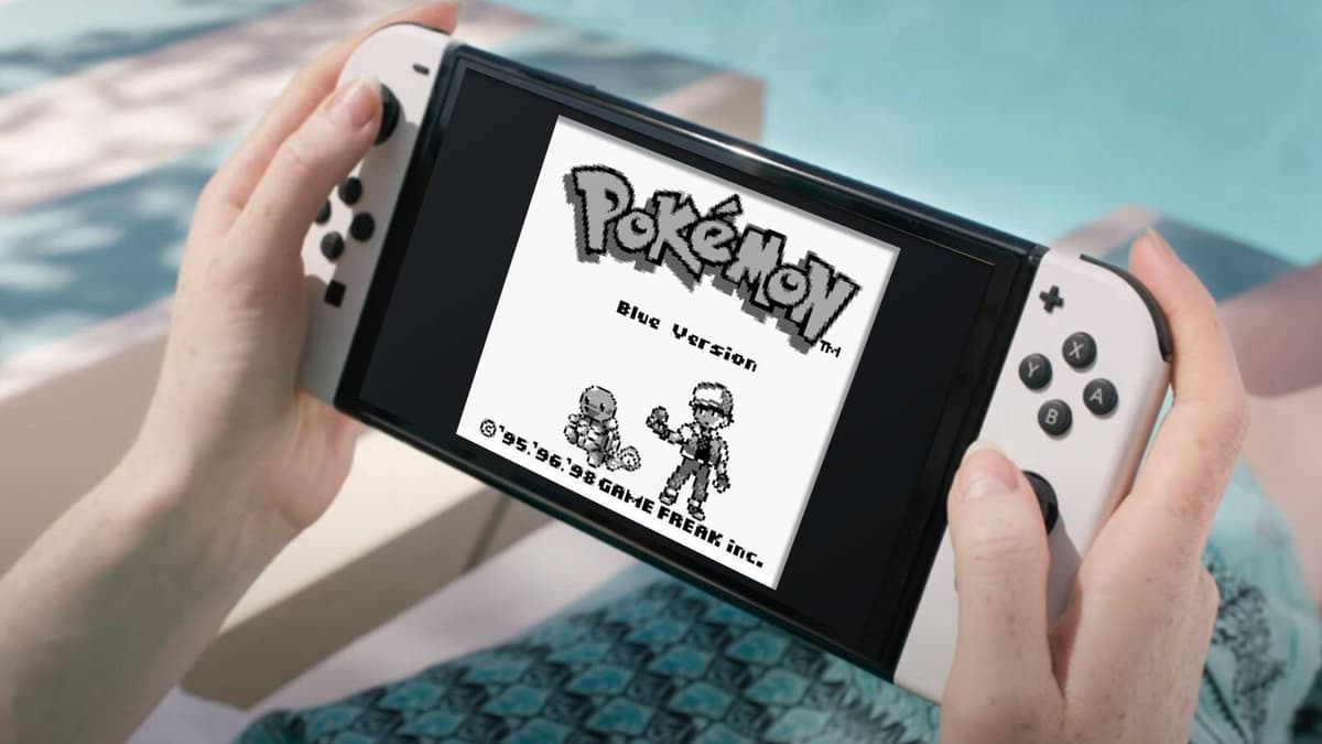 A Nintendo Switch OELD is visible with Pokemon Blue on the screen