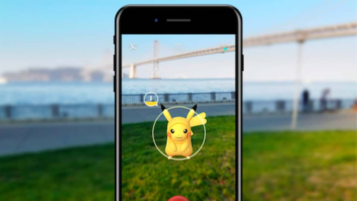 A phone is visible showing a Pokemon Go trainer catching a Pikachu