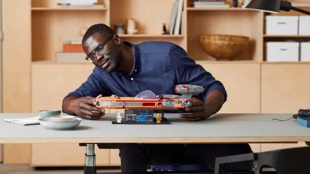 An adult with their LEGO Star Wars Luke Skywalker’s Landspeeder  set