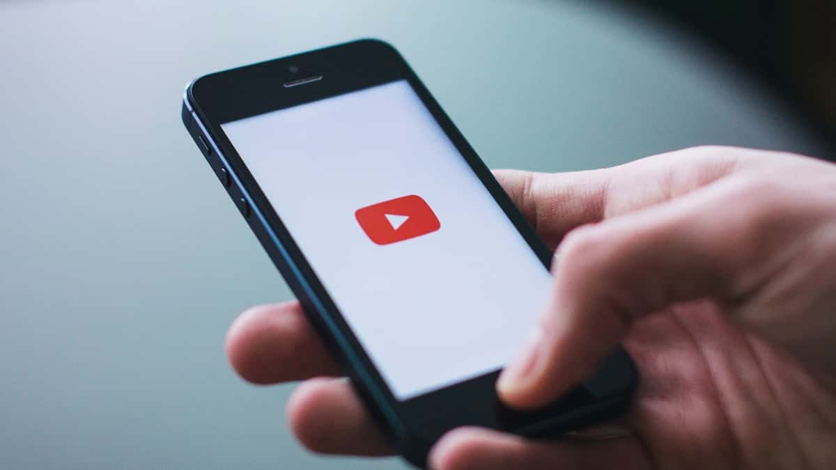 person looking at youtube mobile app on phone