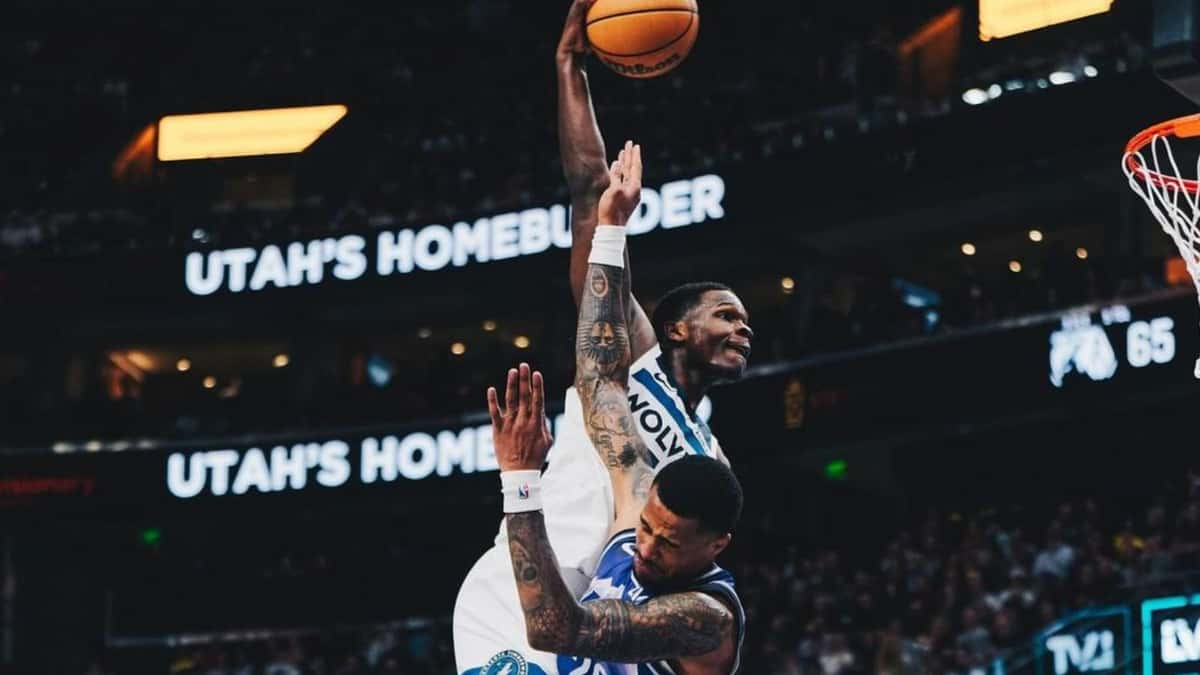 Anthony Edwards dunks over John Collins in the 2023-24 NBA season.