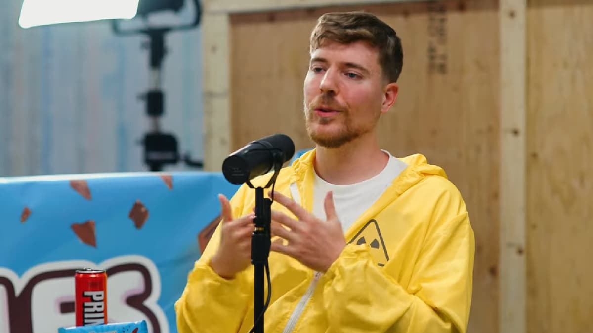 MrBeast wearing yellow hazard suit on podcast set