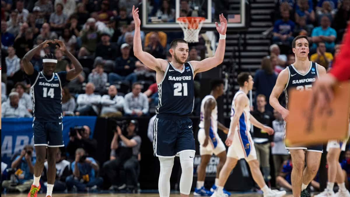 Samford guard Rylan Jones throwing his hands up during matchup against Kansas.