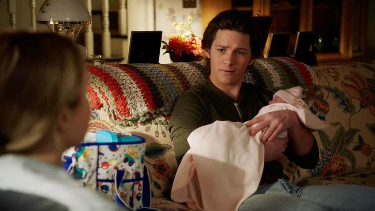 Georgie holding baby Cece in Young Sheldon