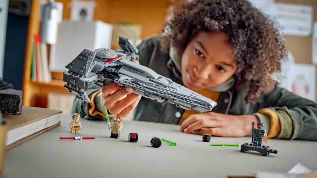 A child playing with their LEGO Star Wars Darth Maul's Sith Infiltrator set