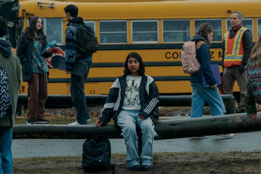 A teenaged girl sits alone on a school bench in Under the Bridge.