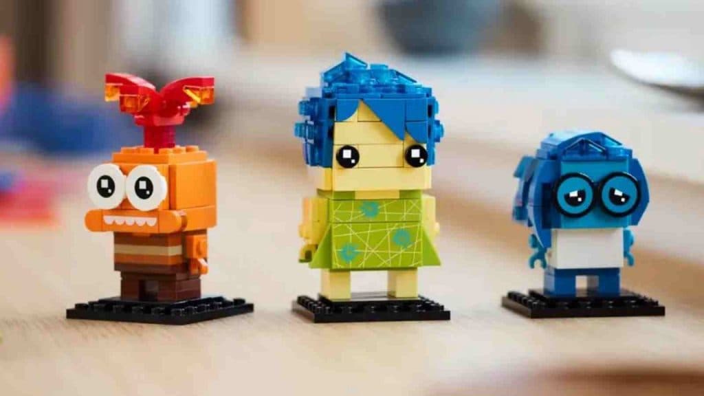 LEGO's buildable figures of Inside Out 2's Joy, Sadness, and Anxiety characters on display