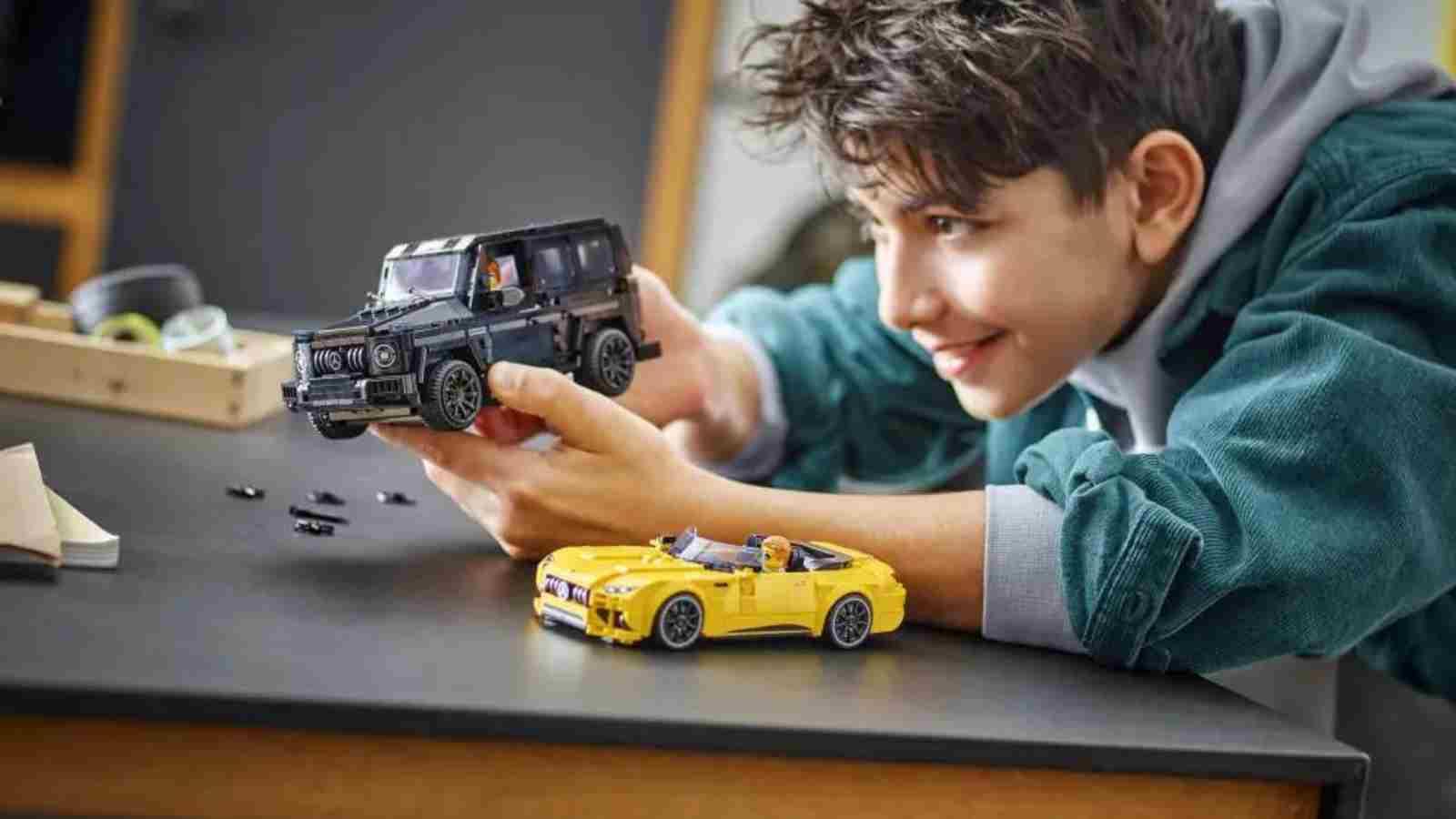 A child playing with the LEGO-reimagined Mercedes-AMGs