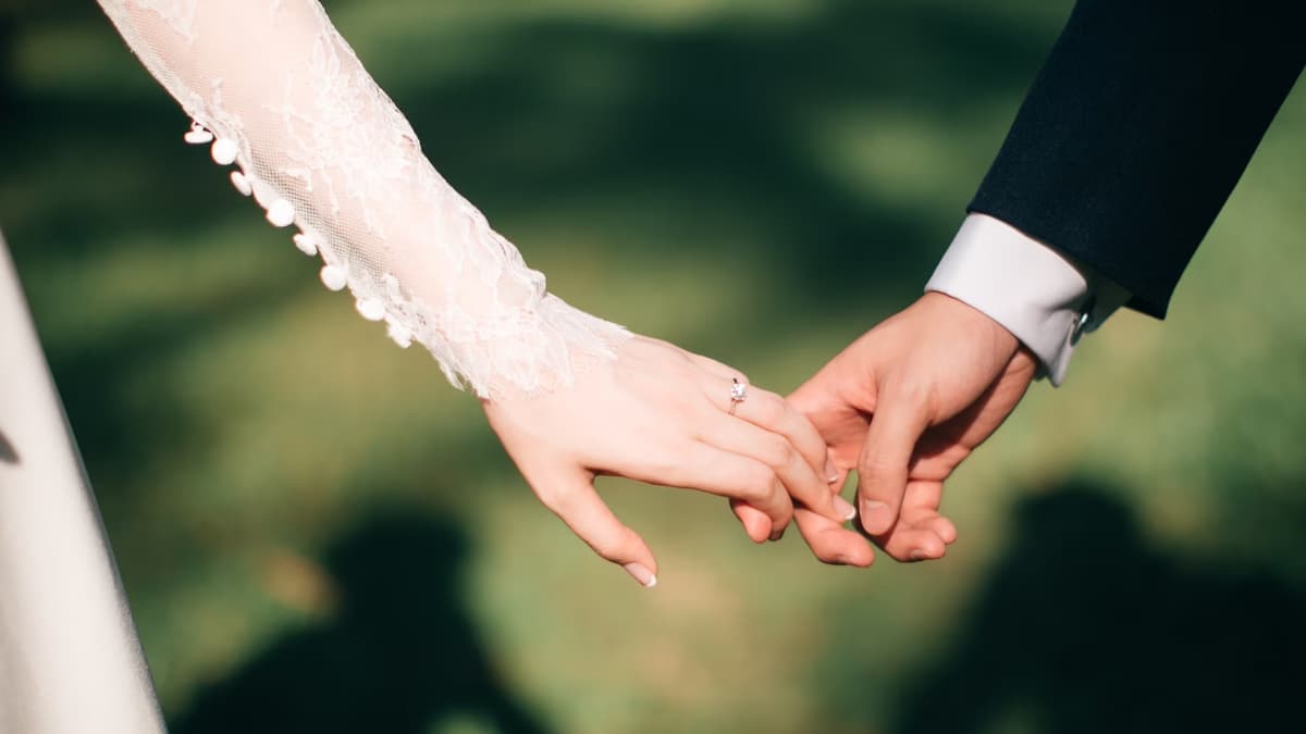 Bride and groom holding hands.