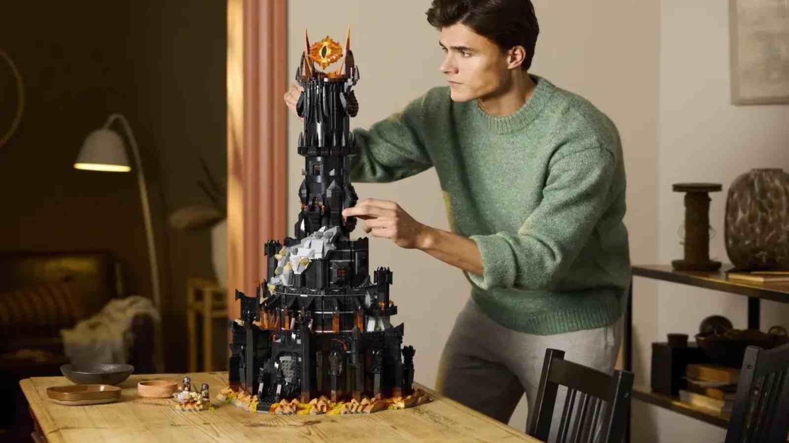 An adult with their The LEGO Icons The Lord of the Rings Barad-dûr set