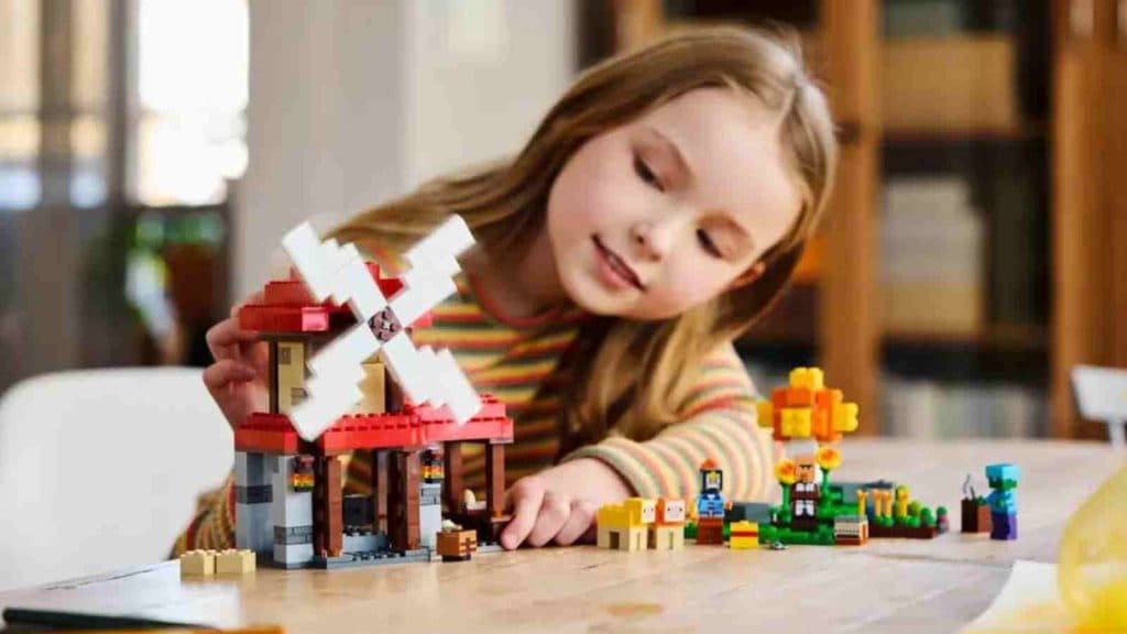 A child with their LEGO Minecraft The Windmill Farm set