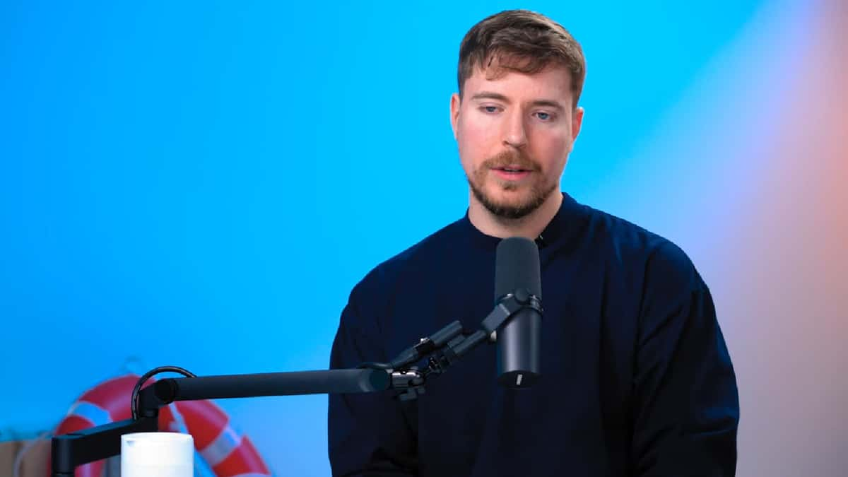 MrBeast sat in front of blue backdrop