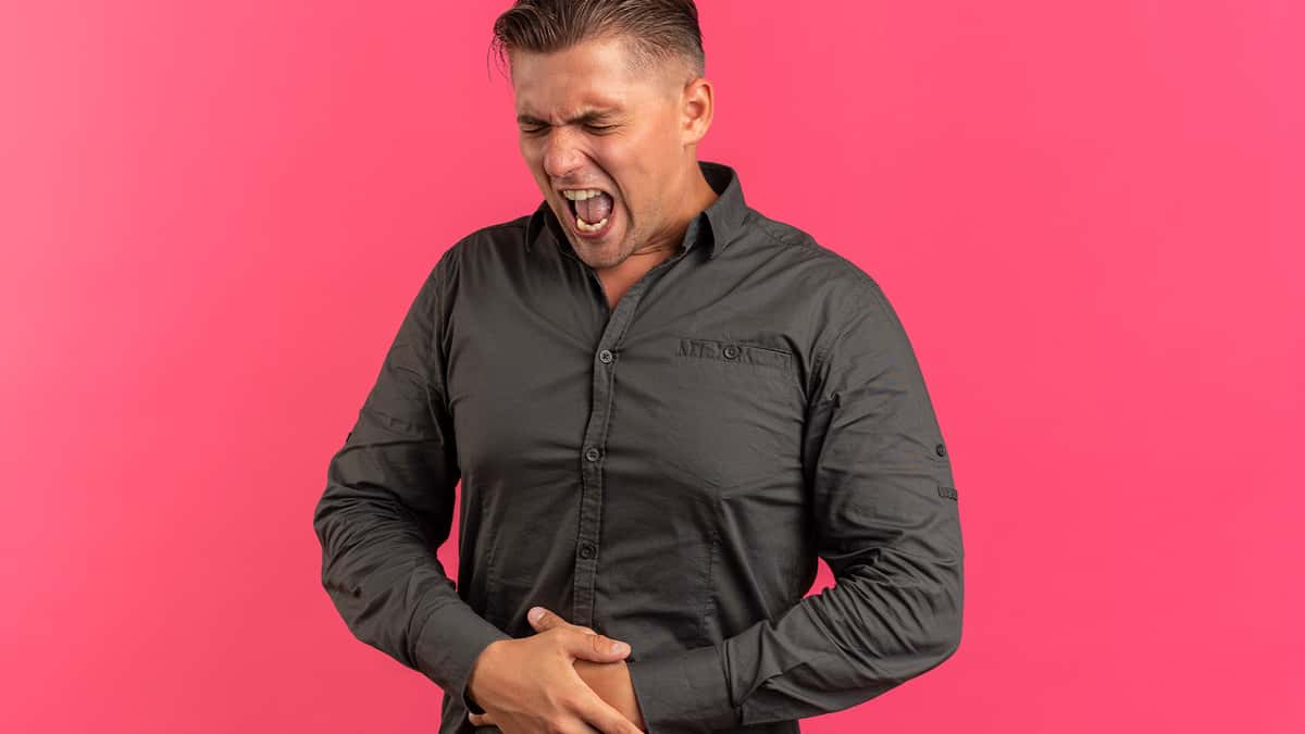 man holding stomach in pain