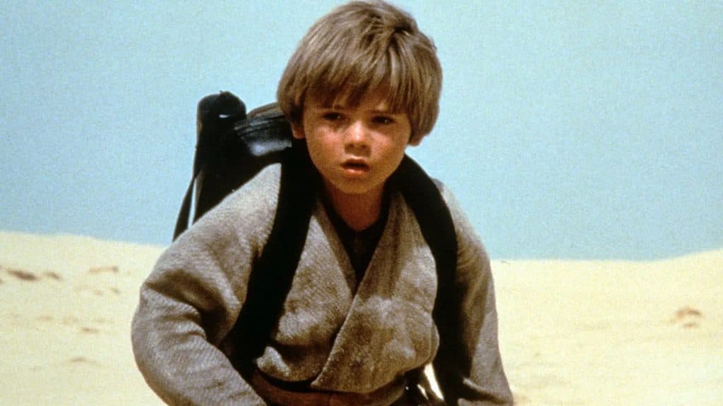 Jake Lloyd running on sand dunes as Anakin Skywalker.