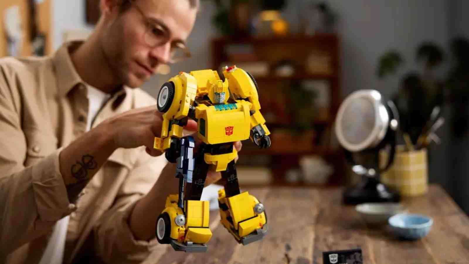 An adult with their LEGO Transformers Bumblebee robot
