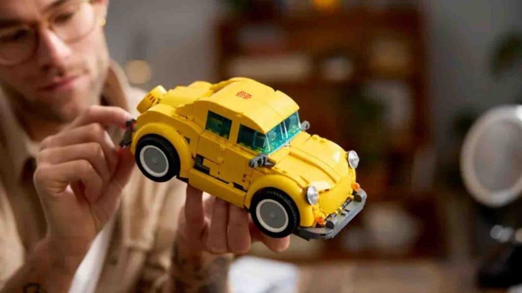 An adult with their LEGO Transformers Bumblebee in car configuration