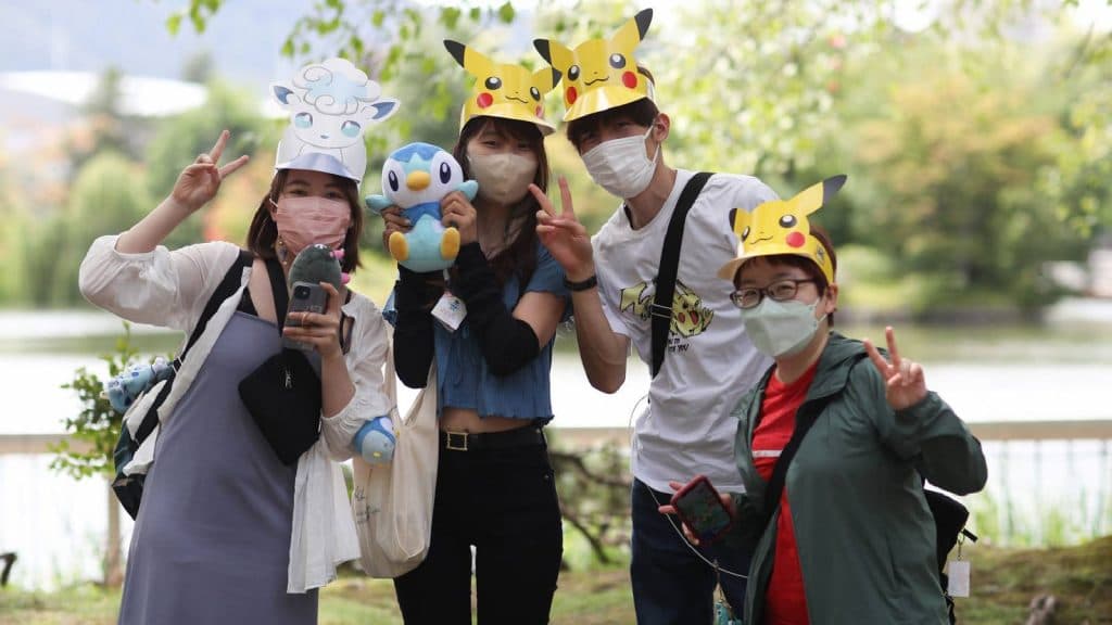 Several people are playing Pokemon Go in a park