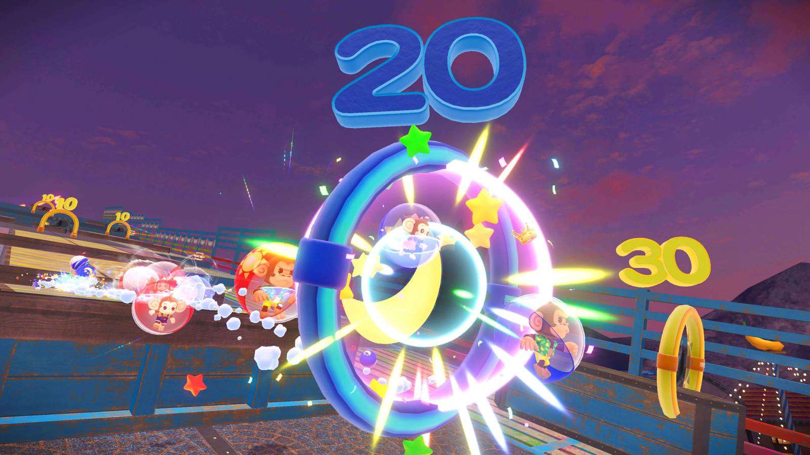 A screenshot from Super Monkey Ball Banana Rumble shows monkeys earning points by moving through a goal