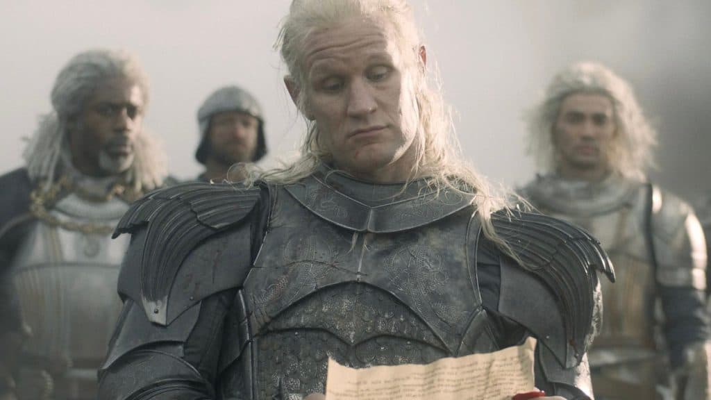 Daemon Targaryen looks nonplussed as he reads a letter.