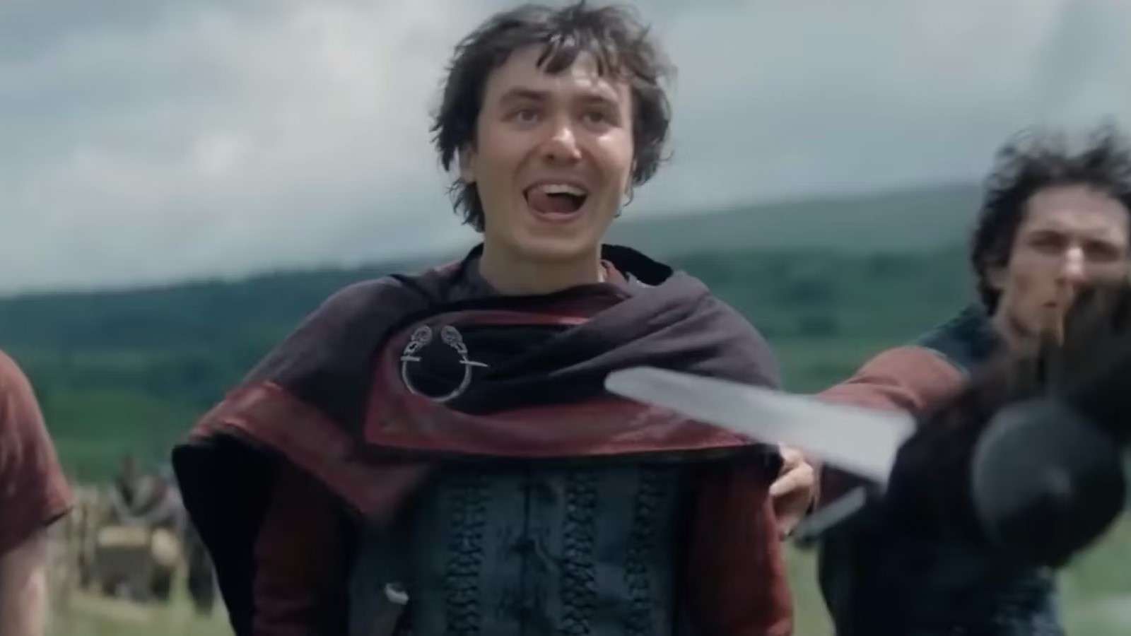 Samwell Blackwood in House of the Dragon, sticking his tongue out as someone holds a sword to his chest