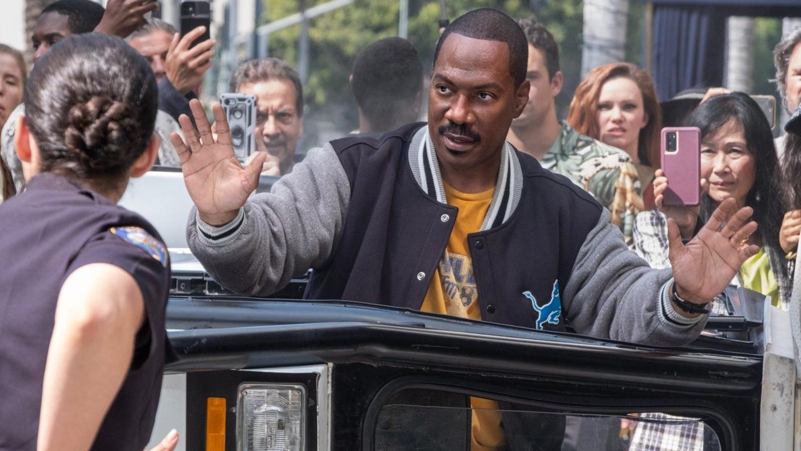 Eddie Murphy holding his hands up as Axel Foley in Beverly Hills Cop 4.