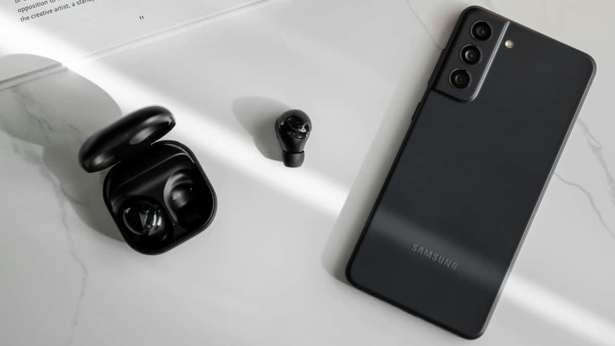 Samsung Galaxy smartphone next to Samsung earbuds