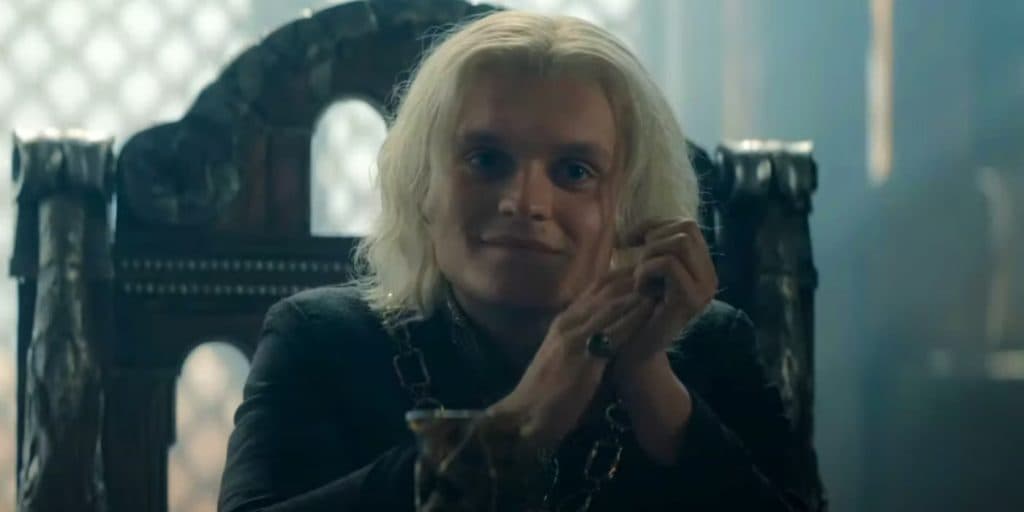 Tom Glynn-Carney as King Aegon in House of the Dragon, sitting in his Small Council meeting