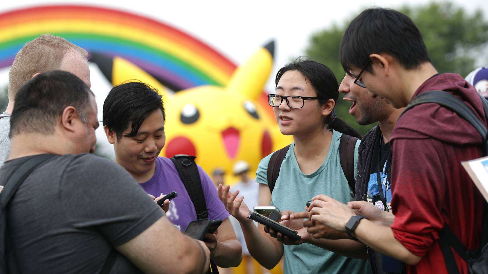 Several Pokemon Go players gather together in a park