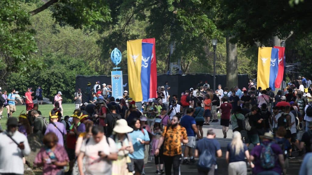 Hundreds of Pokemon Go players wander through New York City's Randall Park as part of Pokemon Go Fest