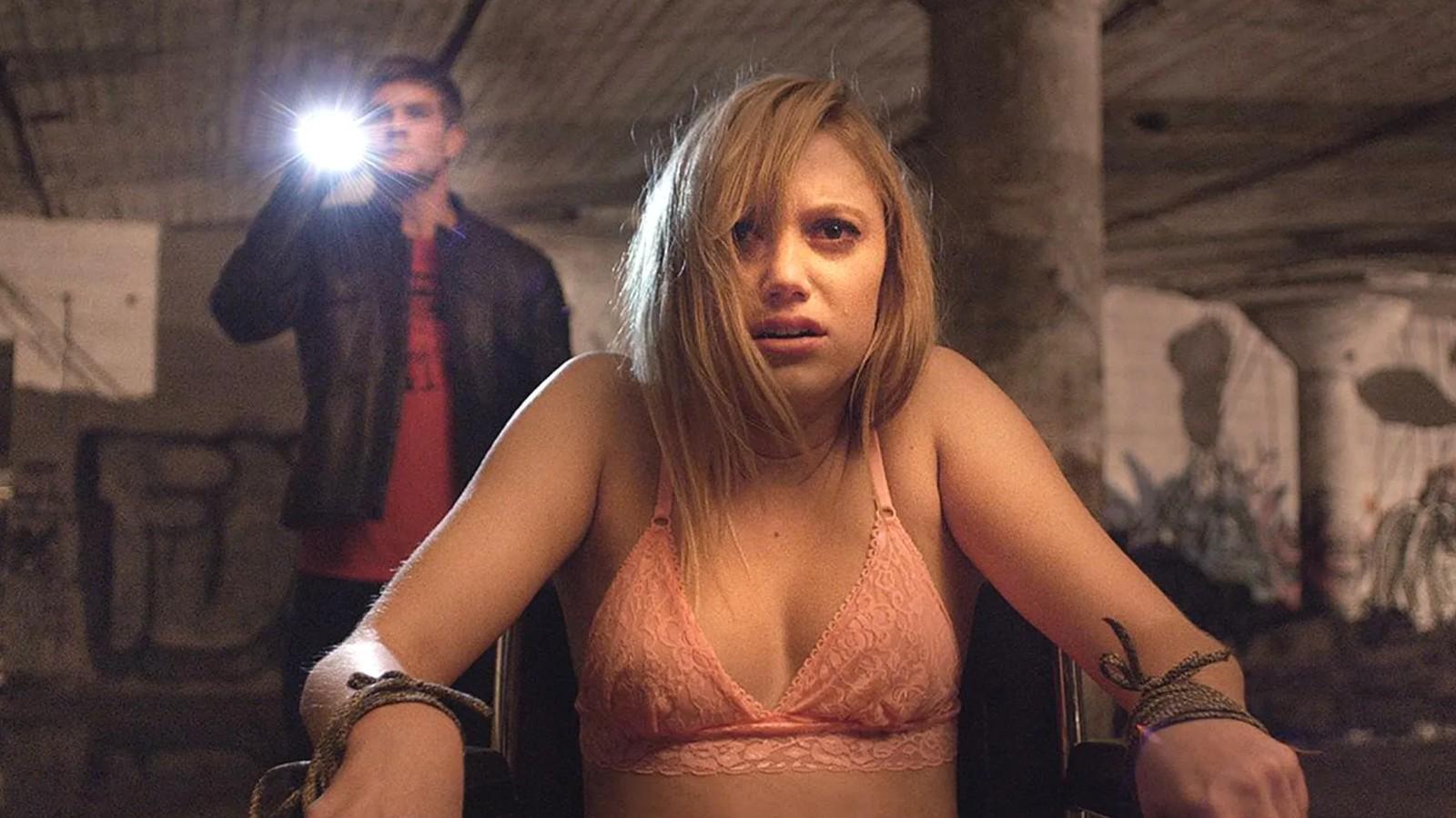 Maika Monroe tied to a chair in It Follows.