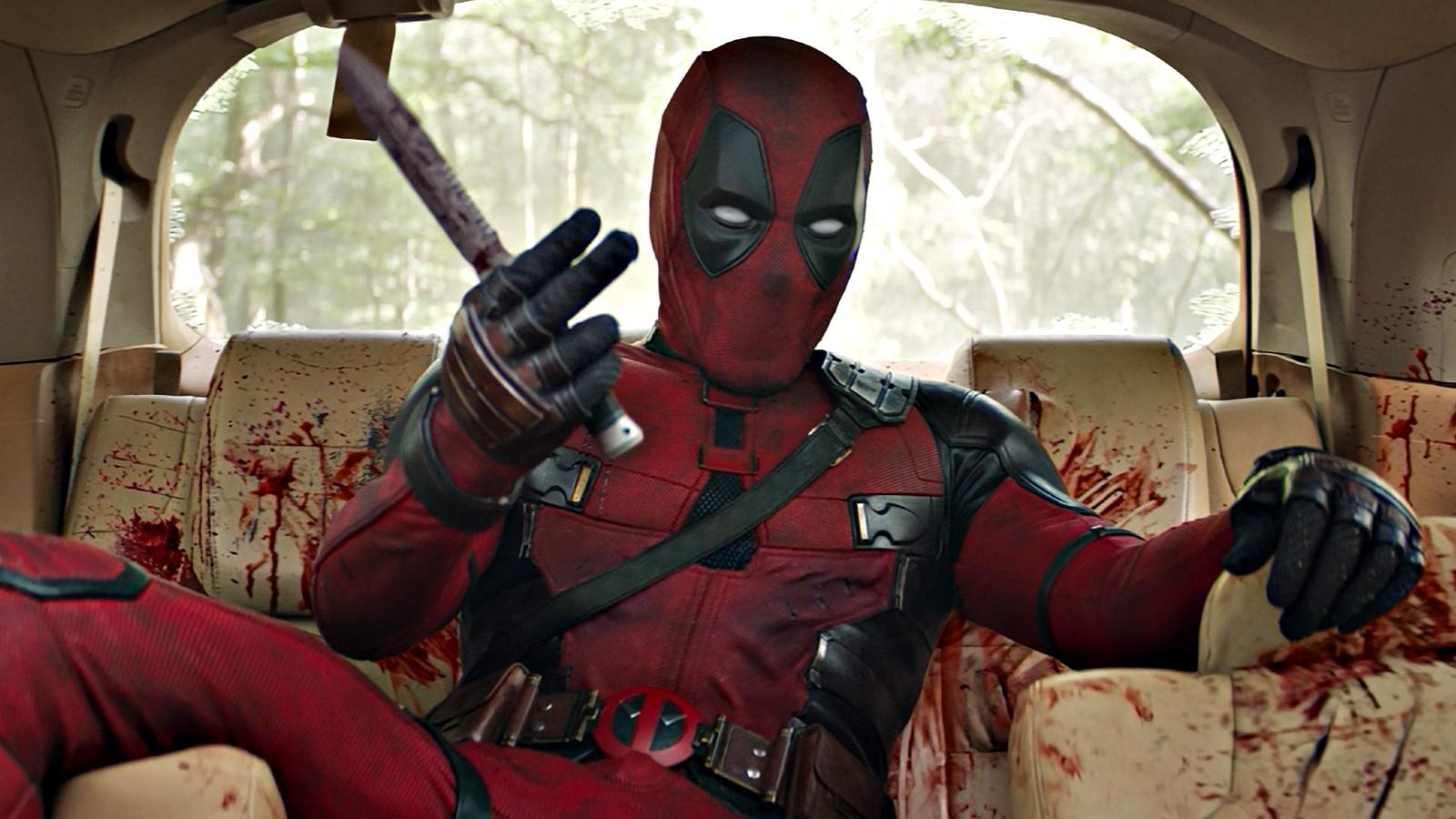 A still of Deadpool covered in bloo