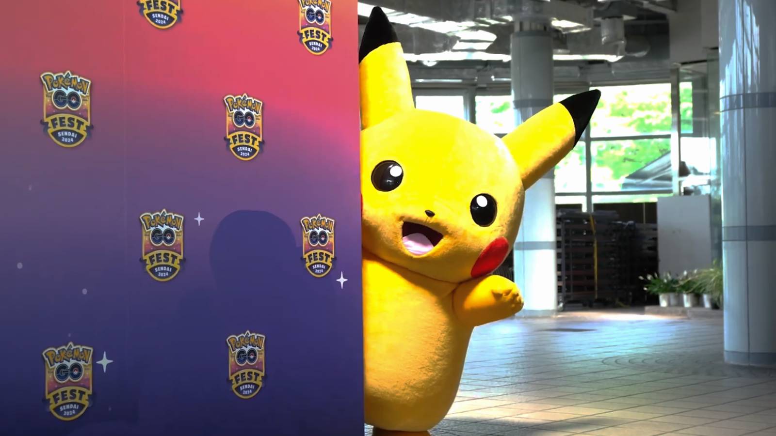A still photograph from Pokemon Go Fest 2024 Sendai shows a person in a Pikachu costume peaking out from behind a wall