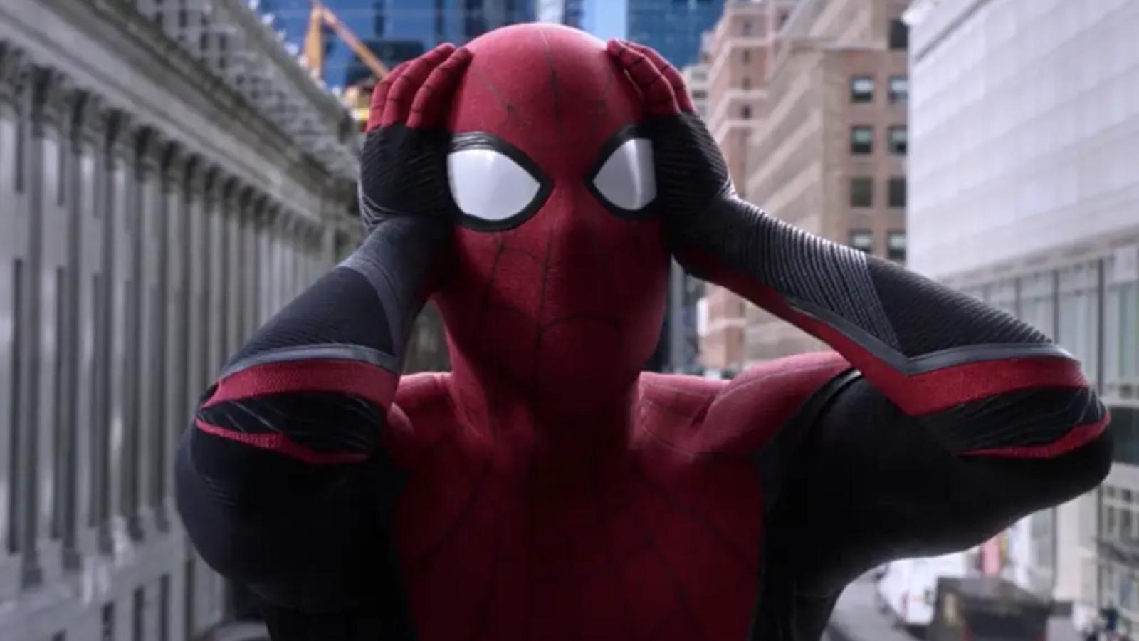 Spider-Man holds his head in his hands in shock