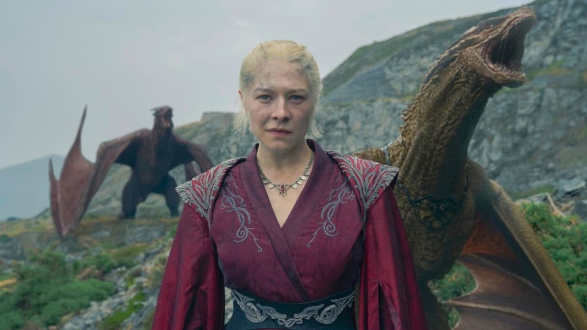 House of the Dragon Season 3: Emma D'Arcy as Rhaenyra Targaryen, standing on a hill with dragons behind her