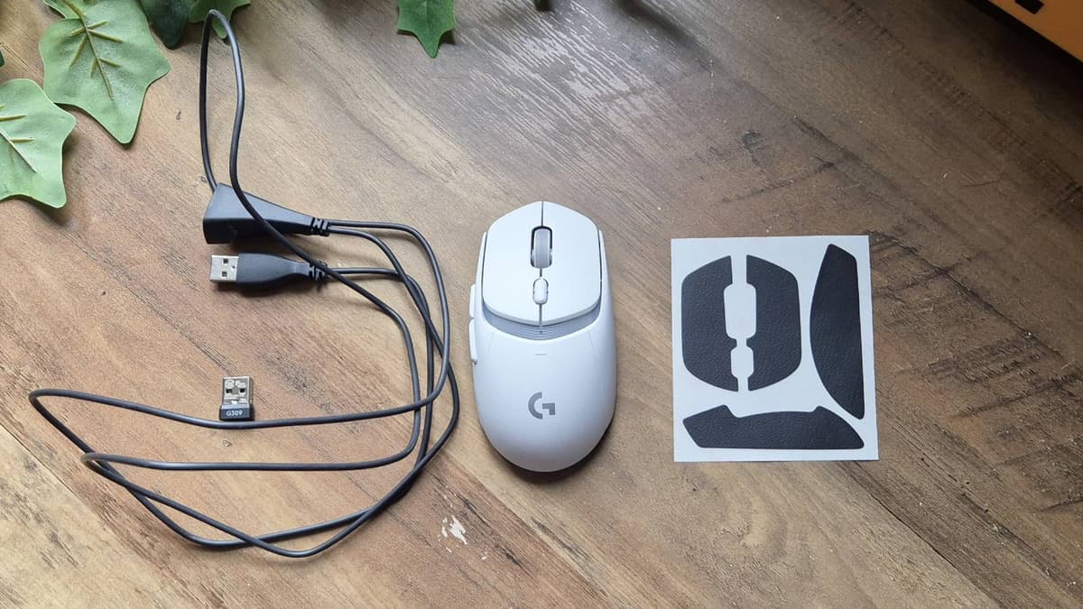 Custom photo of the Logitech G309 mouse on a wooden table.