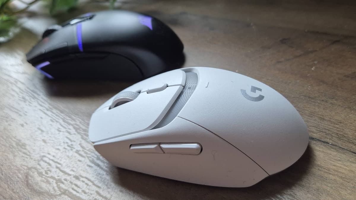 Custom photo of the Logitech G309 mouse on a wooden table.