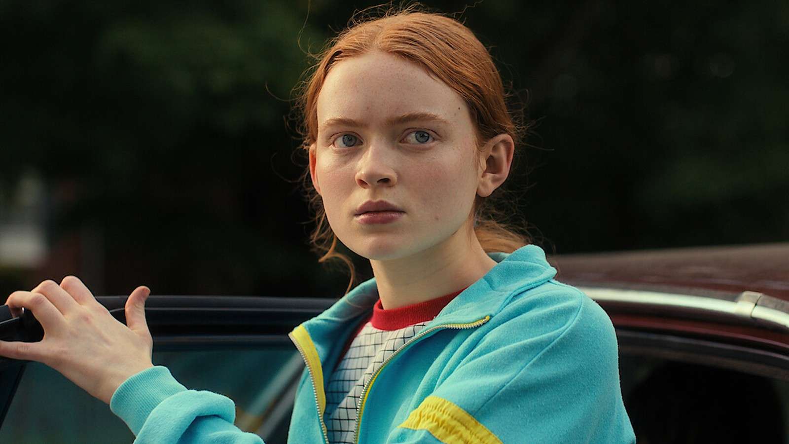 Sadie Sink as Max wearing a blue top in Stranger Things.